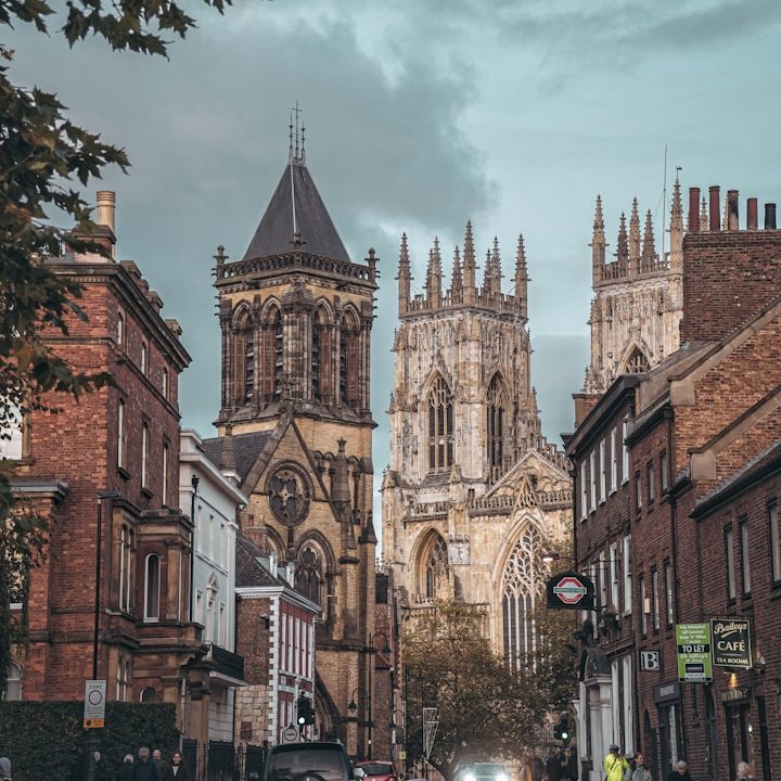 View of York Minster surrounded by historic buildings and a cloudy sky.